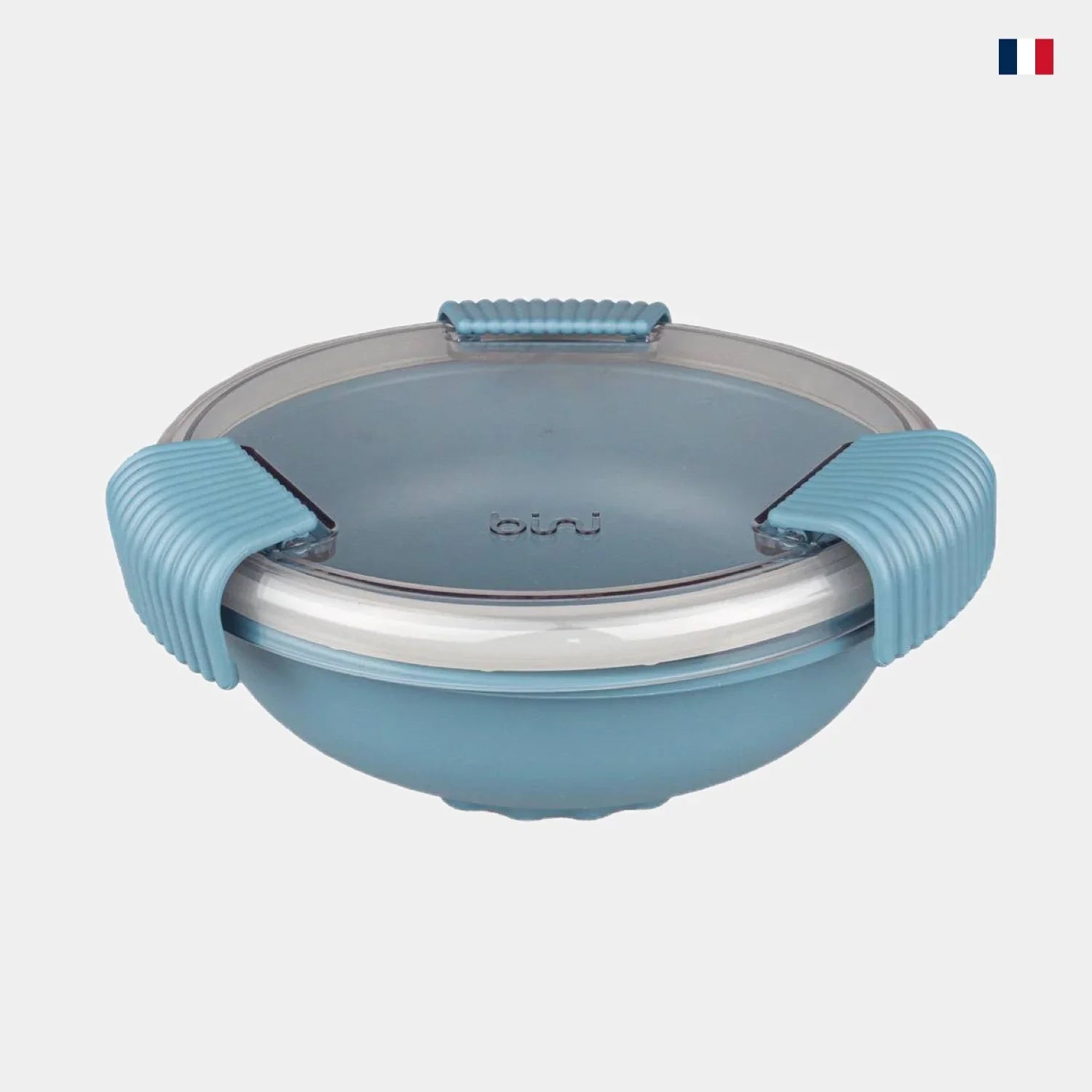 Lunch box ronde bleue avec couvercle hermétique et clips, sur fond gris clair